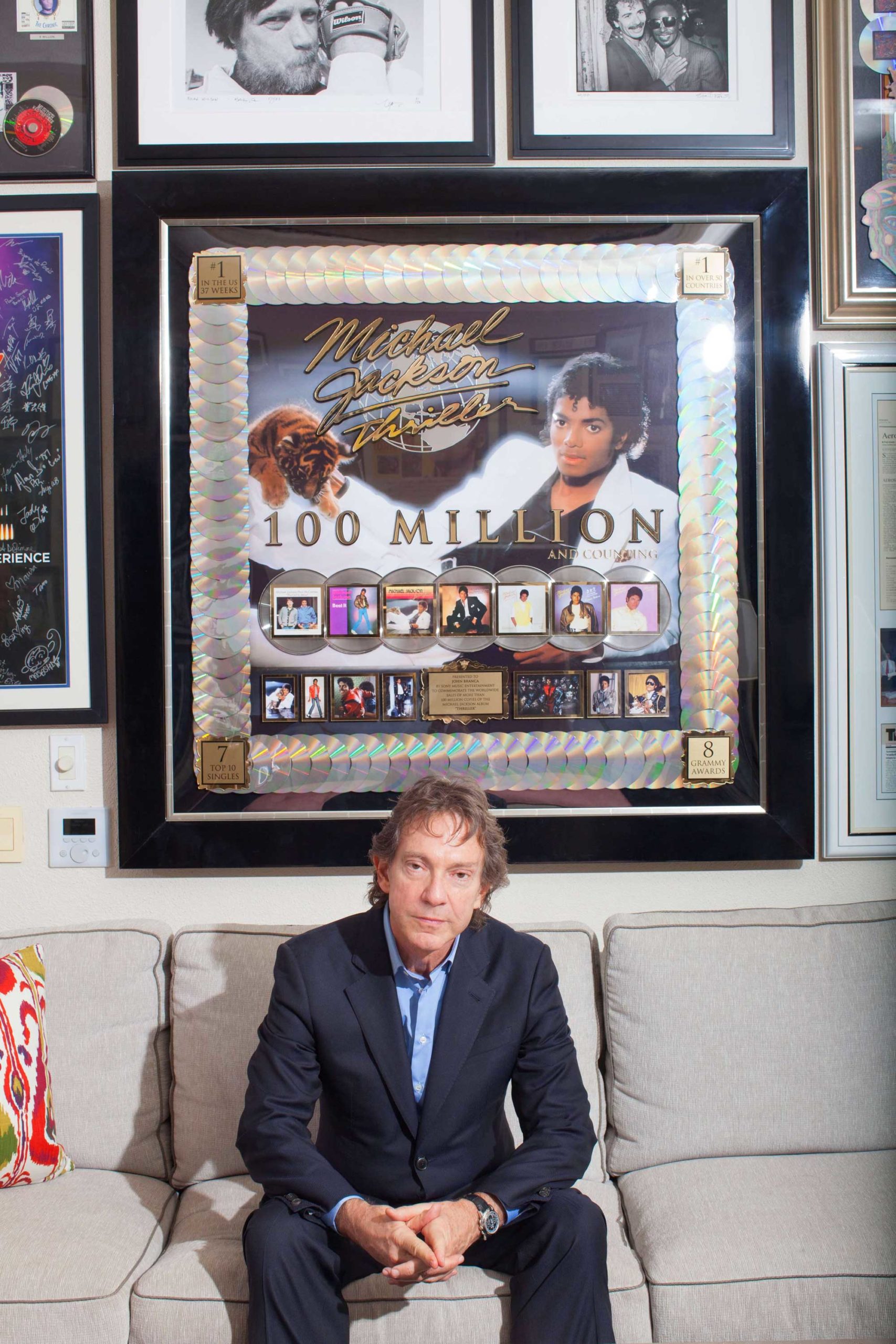 John-with-100-million-Thriller-award-2-scaled.jpg